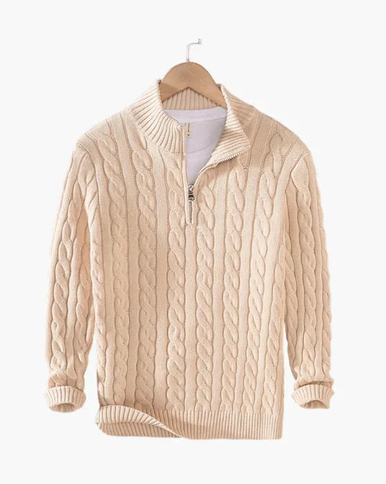 Beige cable knit quarter zip sweater on hanger against white background