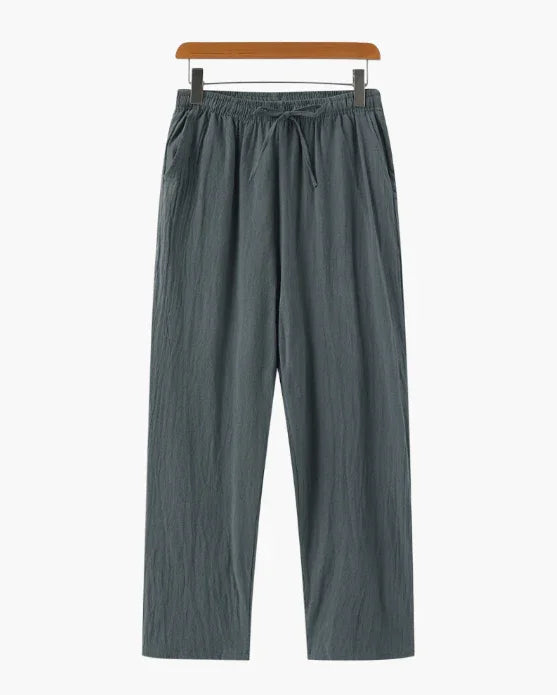 Loose fit gray drawstring pants with an elastic waist, displayed on a hanger