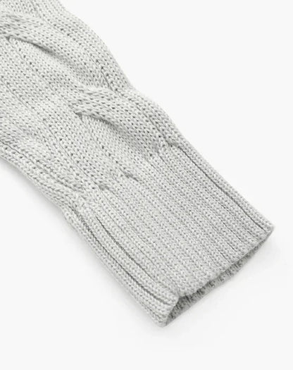 Light gray cable knit sweater sleeve with ribbed cuff on white background