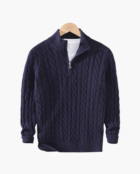 Navy blue cable knit quarter zip sweater on wooden hanger against white background