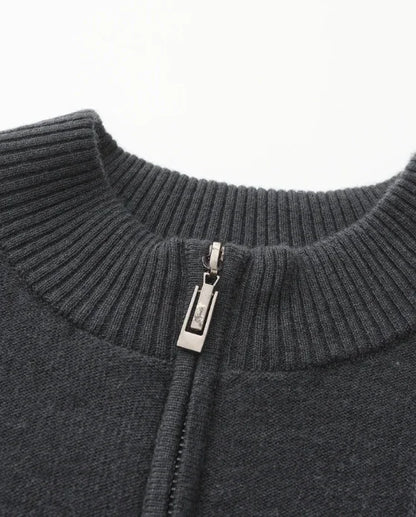 Close-up of charcoal knit zip-up sweater collar with ribbed neckline
