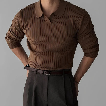 Man wearing ribbed brown sweater with collar and dark pleated trousers, minimalist style